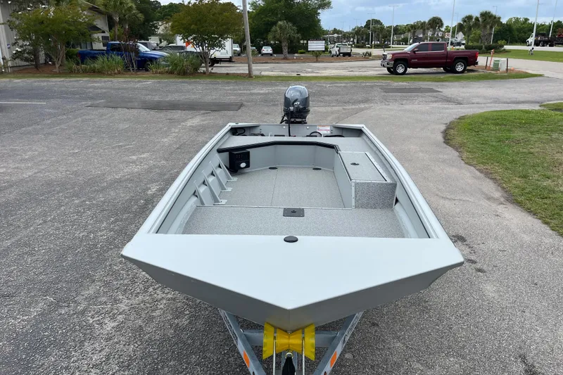 Slide: The Image of 2026 SeaArk DXS 1652 DKLD boat on trailer, parked outdoors. - 7