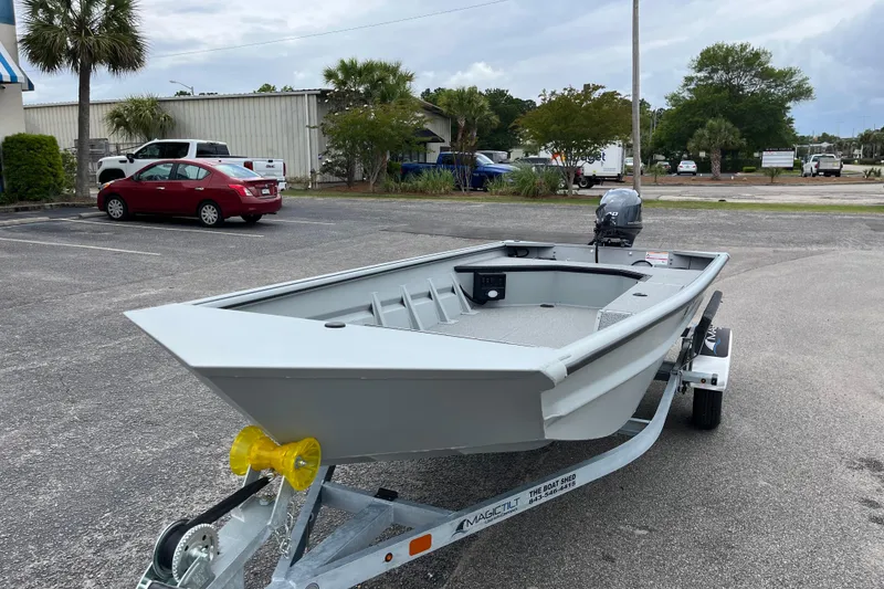 Slide: The Image of 2026 SeaArk DXS 1652 DKLD boat on trailer in parking lot, ready for transport. - 8