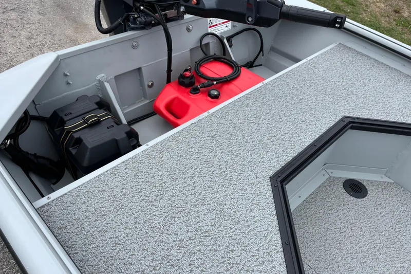 Slide: The Image of 2026 SeaArk DXS 1652 DKLD boat interior with battery and fuel tank setup. - 9