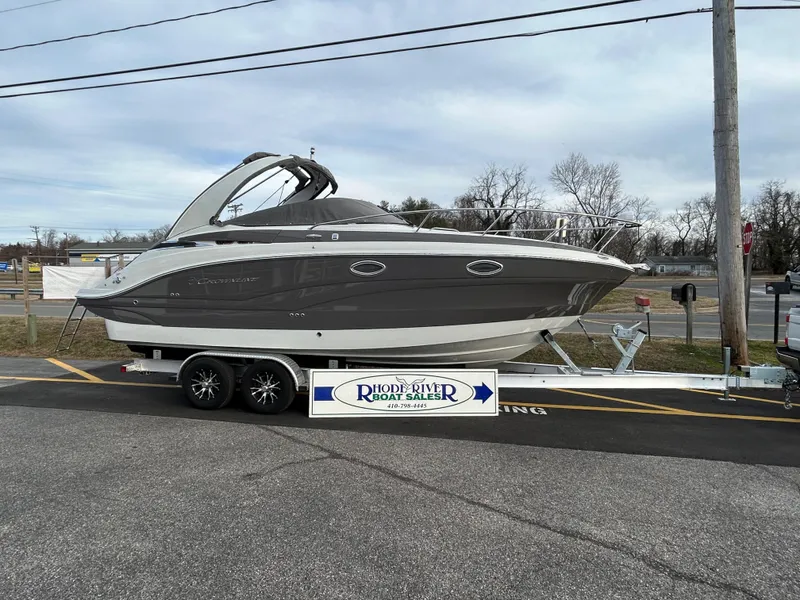 The Image of 2023 Crownline 270 CR boat on trailer, gray design, parked outdoors. - 0