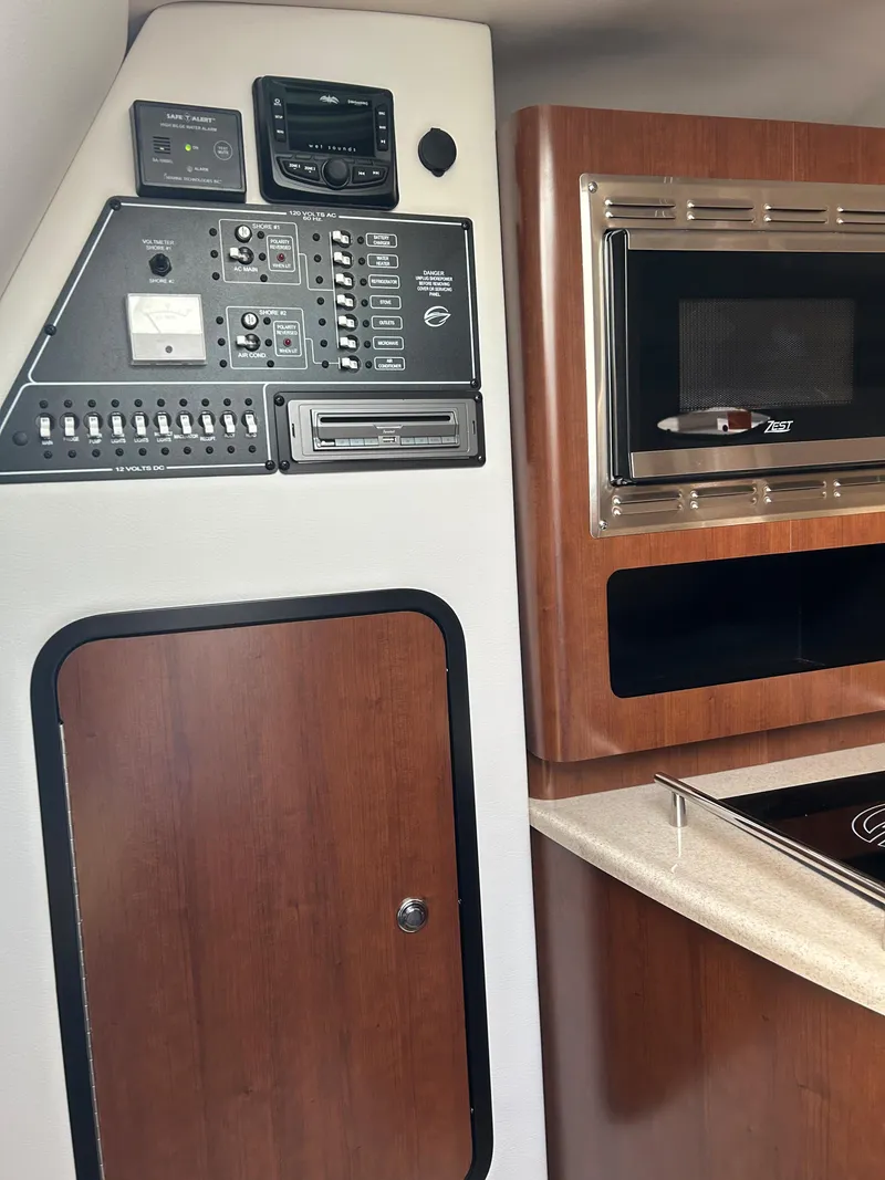 Slide: The Image of Interior of 2023 Crownline 270 CR with control panel and microwave. - 12