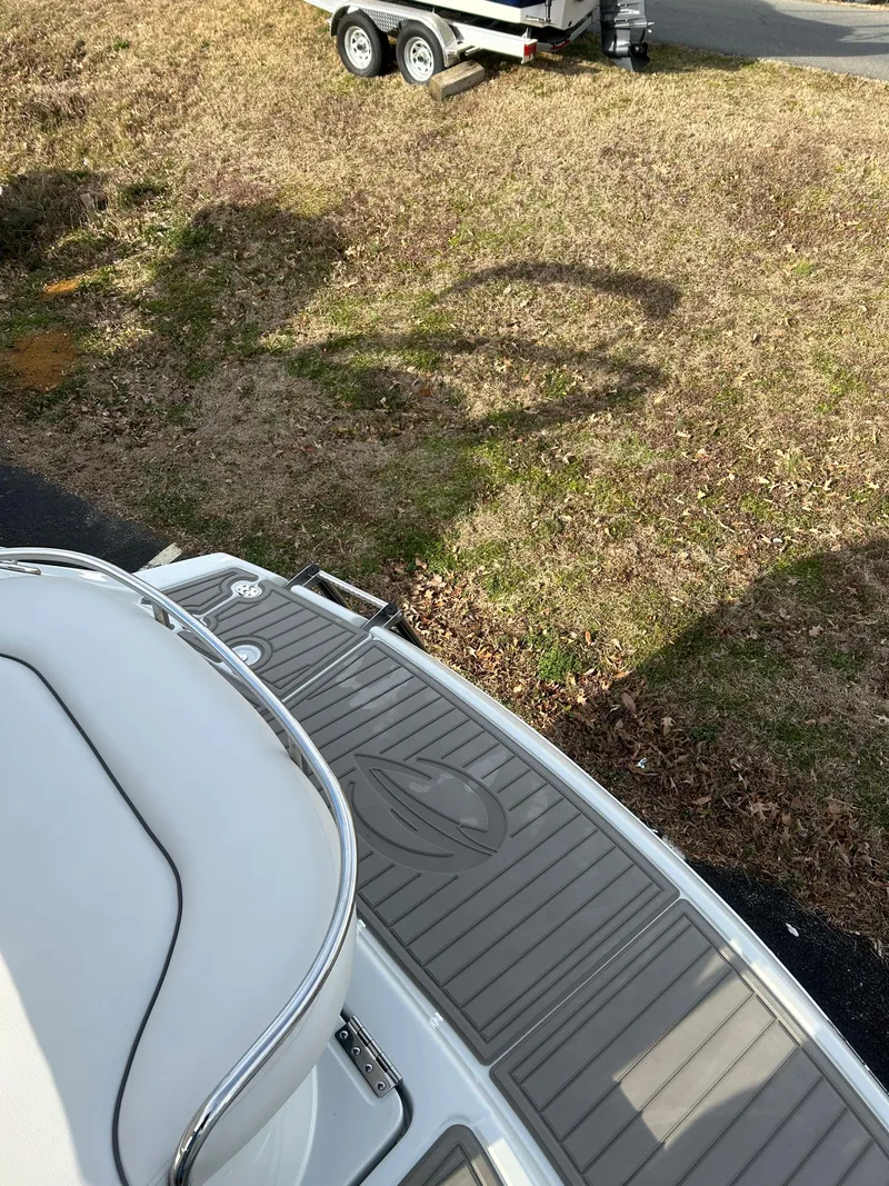 Slide: The Image of Crownline 270 CR 2023 boat with gray deck and trailer in background. - 4