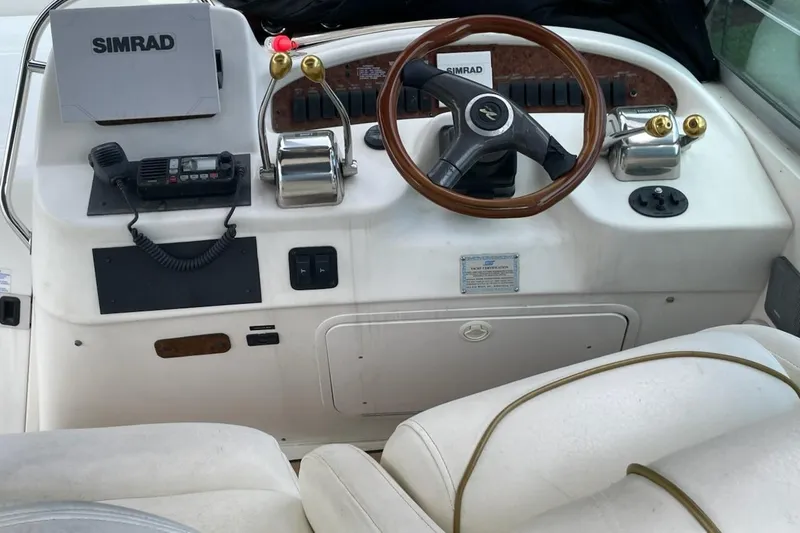 Slide: The Image of Cockpit of 2000 Sea Ray 290 Sundancer with steering wheel and controls. - 10
