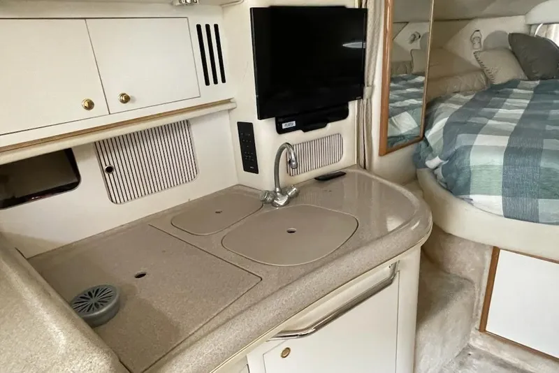 Slide: The Image of Interior of 2000 Sea Ray 290 Sundancer with kitchenette and bed. - 5
