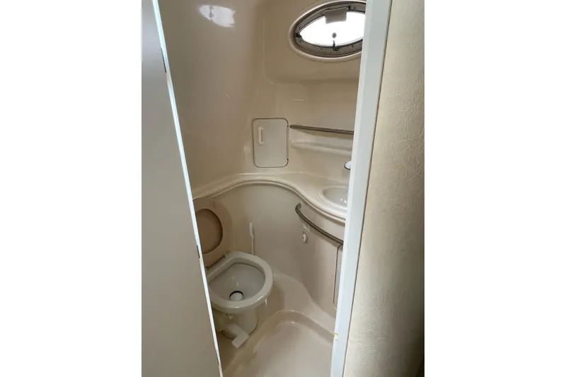 Slide: The Image of 2000 Sea Ray 290 Sundancer bathroom with compact toilet and sink. - 8