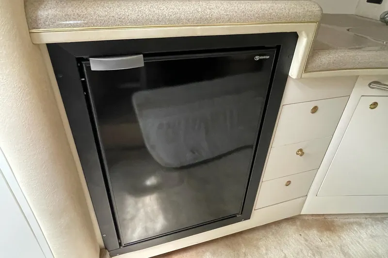 Slide: The Image of Compact refrigerator in 2000 Sea Ray 290 Sundancer boat interior kitchen area. - 9