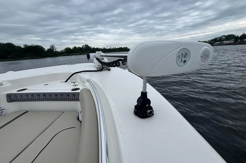 Slide: The Image of 2025 Key West 244 Center Console boat on a calm river under cloudy skies. - 10