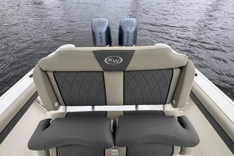 Slide: The Image of 2025 Key West 244 Center Console boat with dual engines on water. - 4