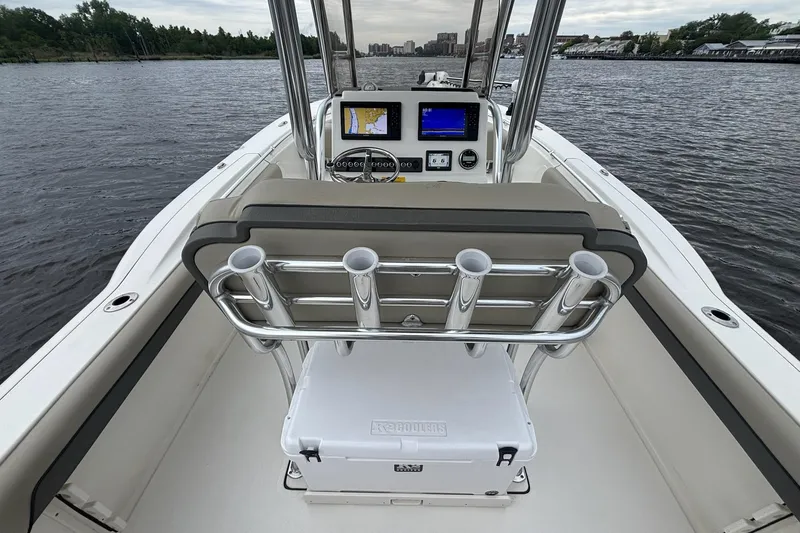 Slide: The Image of 2025 Key West 244 Center Console boat interior with navigation screens on a calm river. - 6