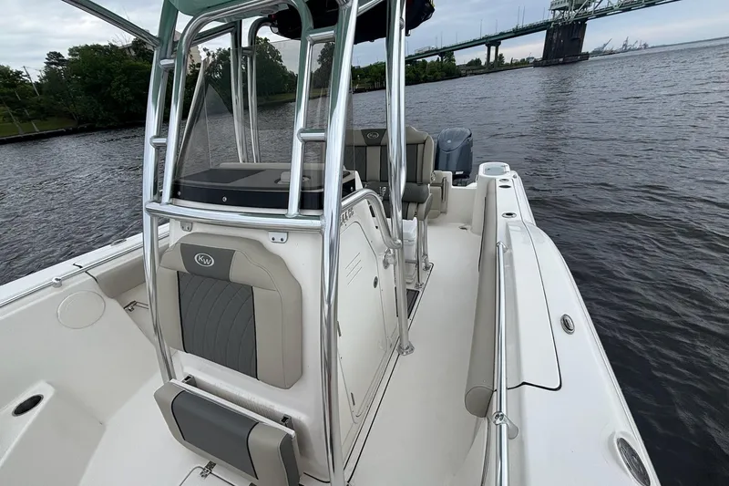 Slide: The Image of 2025 Key West 244 Center Console boat on water near a bridge, showcasing sleek design. - 7