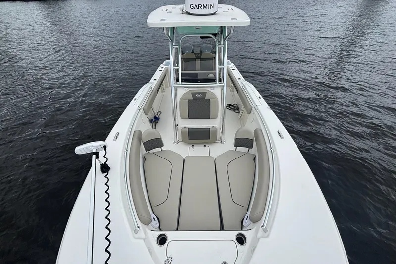 Slide: The Image of 2025 Key West 244 Center Console boat on water, featuring spacious seating and Garmin equipment. - 8