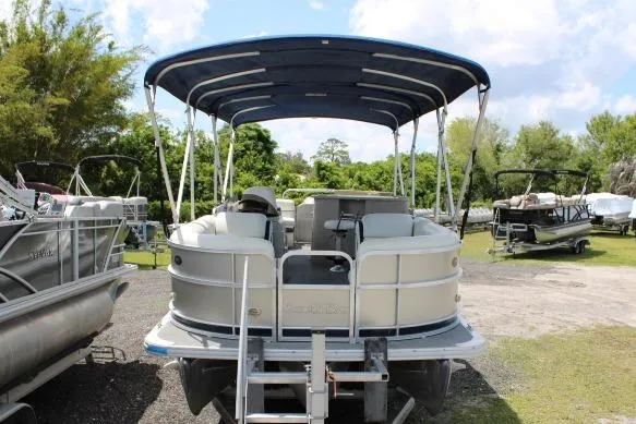The Image of 2015 South Bay 524E pontoon boat with canopy, parked outdoors on a sunny day. - 0