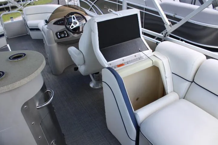 Slide: The Image of Interior of a 2015 South Bay 524E pontoon boat with seating and helm. - 14