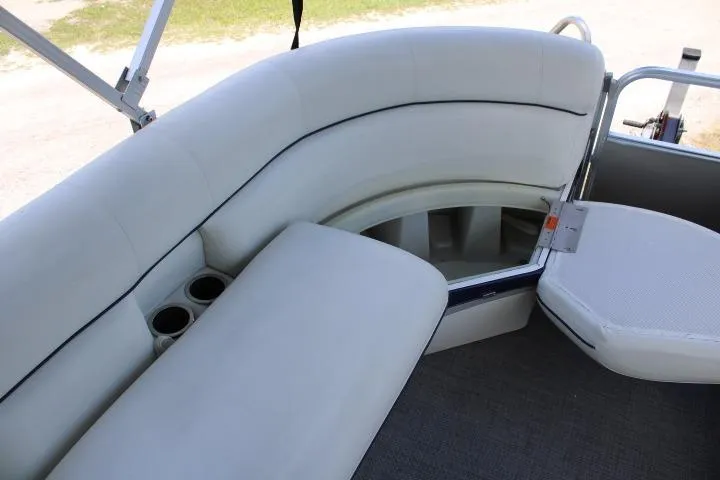 Slide: The Image of Luxurious seating on a 2015 South Bay 524E pontoon boat with cup holders and storage. - 15