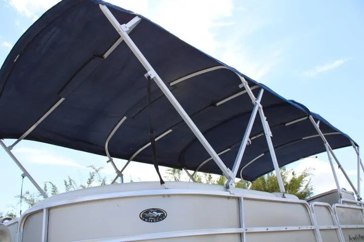 Slide: The Image of 2015 South Bay 524E pontoon boat with blue canopy under clear sky. - 16