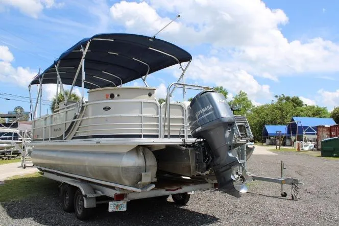 Slide: The Image of 2015 South Bay 524E pontoon boat with Yamaha motor on trailer, parked outdoors. - 3