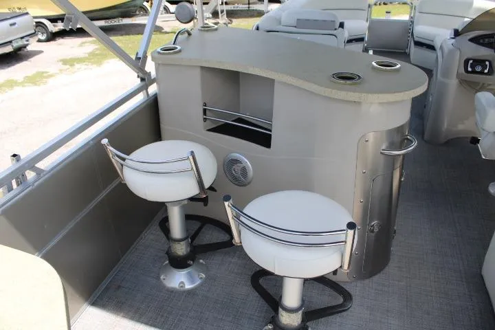 Slide: The Image of Luxury 2015 South Bay 524E pontoon boat interior with bar and swivel stools. - 7