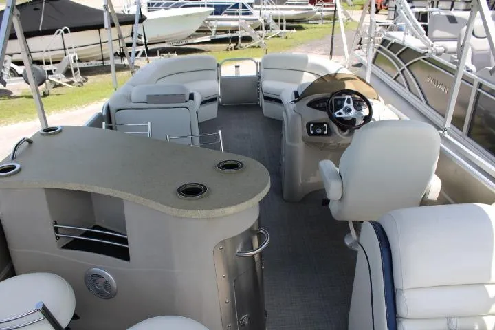 Slide: The Image of Interior of a 2015 South Bay 524E pontoon boat with seating and helm. - 8