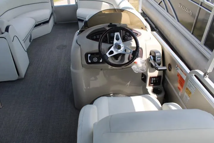 Slide: The Image of Interior view of a 2015 South Bay 524E pontoon boat with steering console. - 9