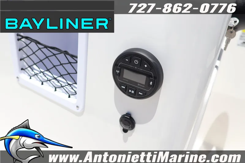 Slide: The Image of 2026 Bayliner Element E18 boat dashboard with Bluetooth controls and storage net. - 15