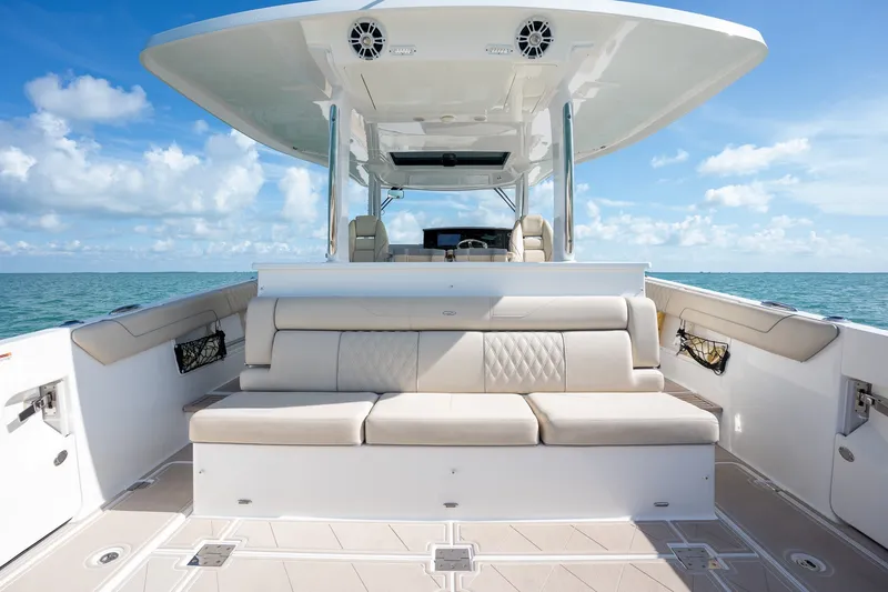 Slide: The Image of Luxurious seating on a 2022 Regal 38 SAV boat with ocean backdrop. - 35