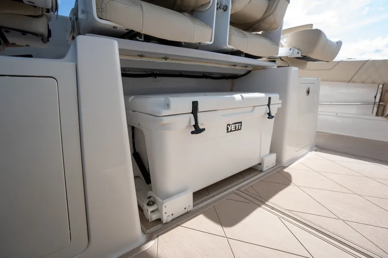 Slide: The Image of 2022 Regal 38 SAV boat with Yeti cooler storage under seating. - 33