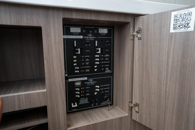 Slide: The Image of Electrical panel inside 2022 Regal 38 SAV boat, showcasing control switches and indicators. - 43