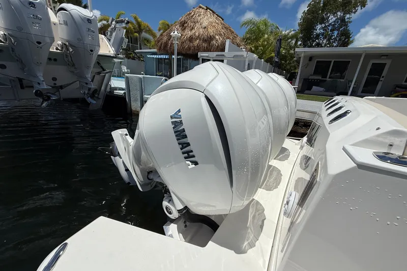Slide: The Image of 2022 Regal 38 SAV boat with Yamaha outboard engines docked by waterfront. - 21