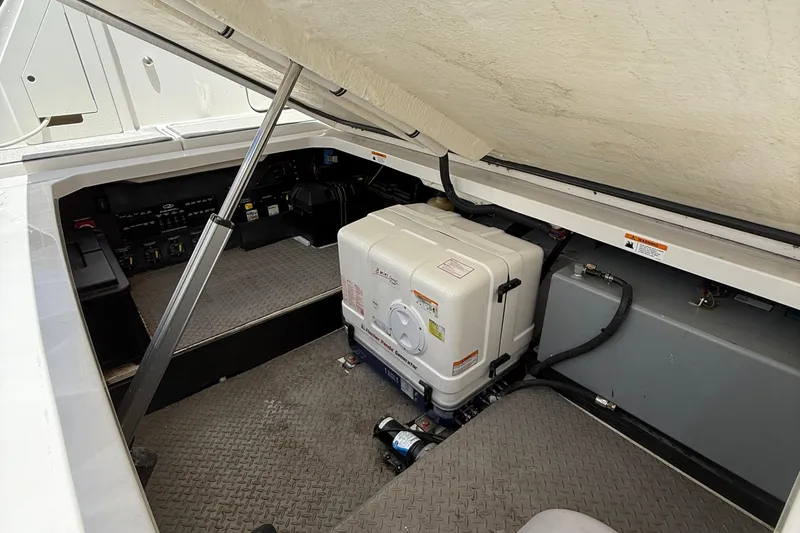 Slide: The Image of 2022 Regal 38 SAV boat engine compartment with generator and control panel. - 32