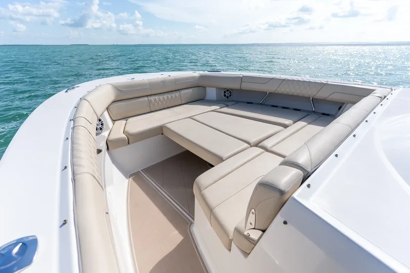 Slide: The Image of Luxurious seating area on a 2022 Regal 38 SAV boat, overlooking serene ocean waters. - 30