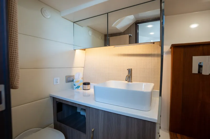 Slide: The Image of Luxurious bathroom interior of 2022 Regal 38 SAV yacht with modern sink and mirror. - 47