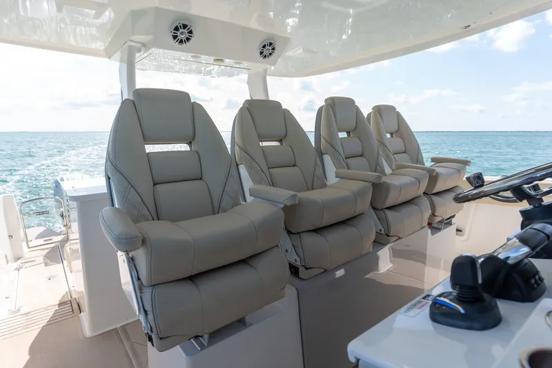 Slide: The Image of Luxurious seating on 2022 Regal 38 SAV boat, featuring four plush captain's chairs. - 28