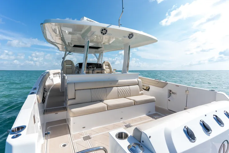 Slide: The Image of 2022 Regal 38 SAV luxury boat interior with seating, ocean view, and clear sky. - 34