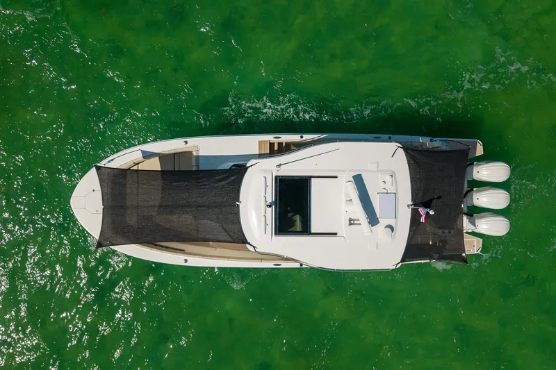 Slide: The Image of Aerial view of 2022 Regal 38 SAV boat on vibrant green water. - 7