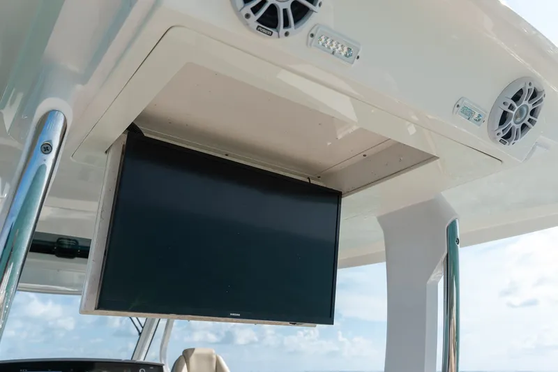 Slide: The Image of 2022 Regal 38 SAV boat with mounted screen and speakers on deck. - 36