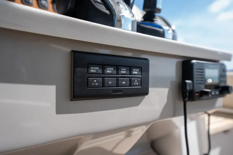 Slide: The Image of Control panel on 2022 Regal 38 SAV boat dashboard with Yamaha navigation buttons. - 40