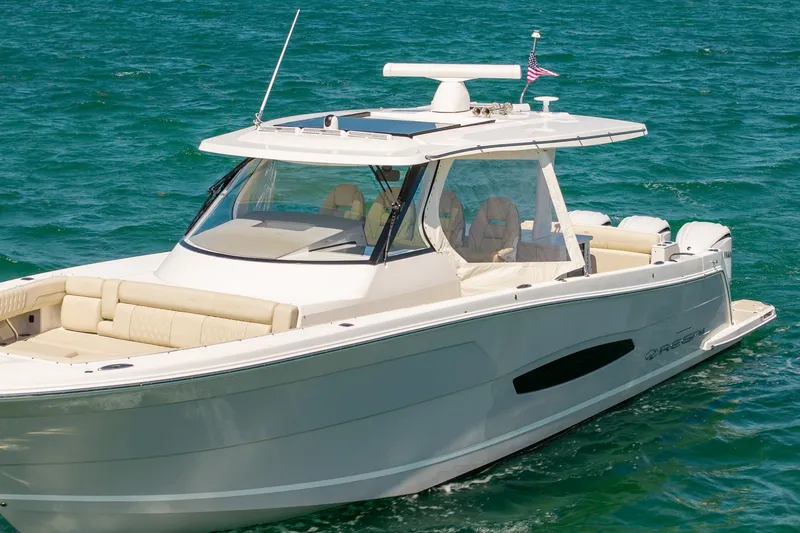 Slide: The Image of 2022 Regal 38 SAV boat cruising on clear blue water. - 11