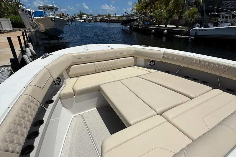 Slide: The Image of Luxurious seating area on 2022 Regal 38 SAV boat docked by the water. - 9