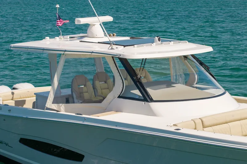 Slide: The Image of 2022 Regal 38 SAV boat on clear blue water, featuring sleek design and comfortable seating. - 12