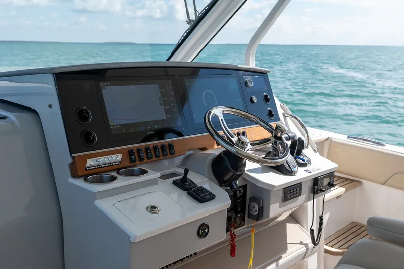Slide: The Image of 2022 Regal 38 SAV boat helm with modern controls and ocean view. - 37