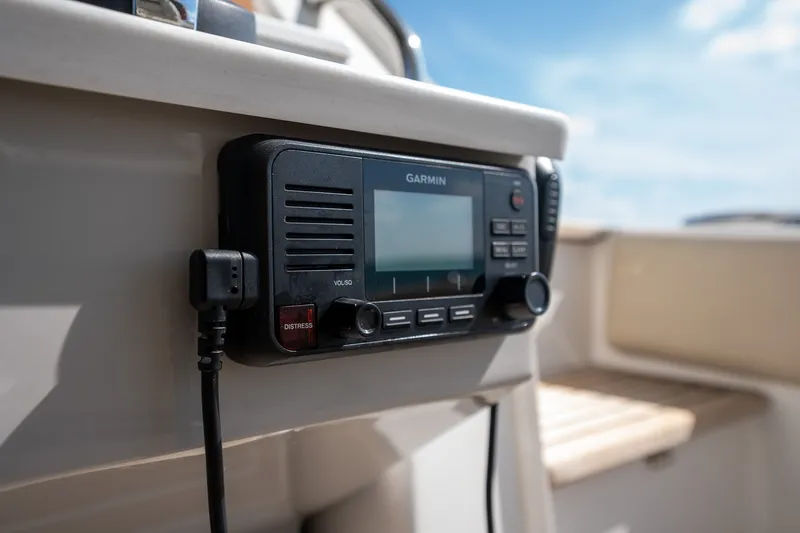 Slide: The Image of Garmin marine radio on 2022 Regal 38 SAV boat, featuring distress button and volume control. - 39