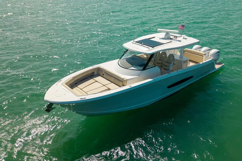 Slide: The Image of 2022 Regal 38 SAV boat cruising on clear turquoise water. - 3