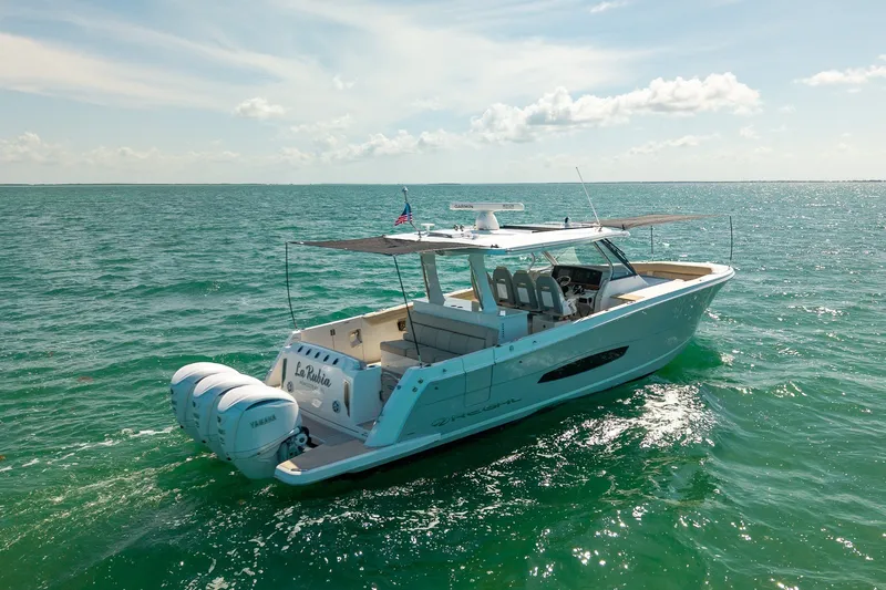 Slide: The Image of 2022 Regal 38 SAV boat cruising on open water under a clear sky. - 8