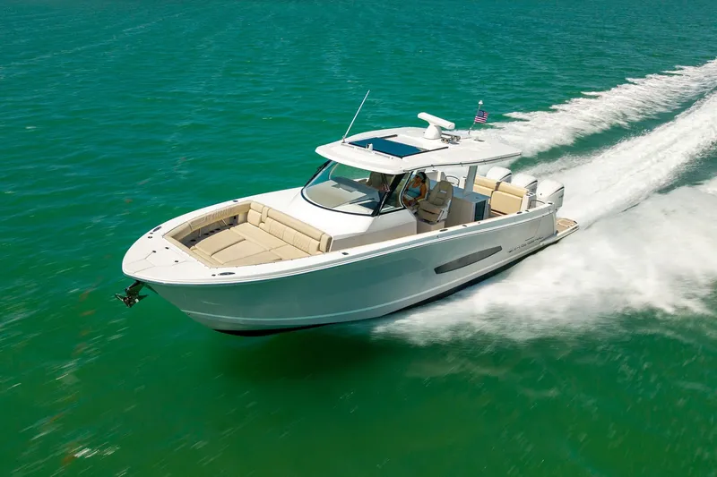 Slide: The Image of 2022 Regal 38 SAV boat cruising on turquoise water, showcasing sleek design and luxury features. - 20