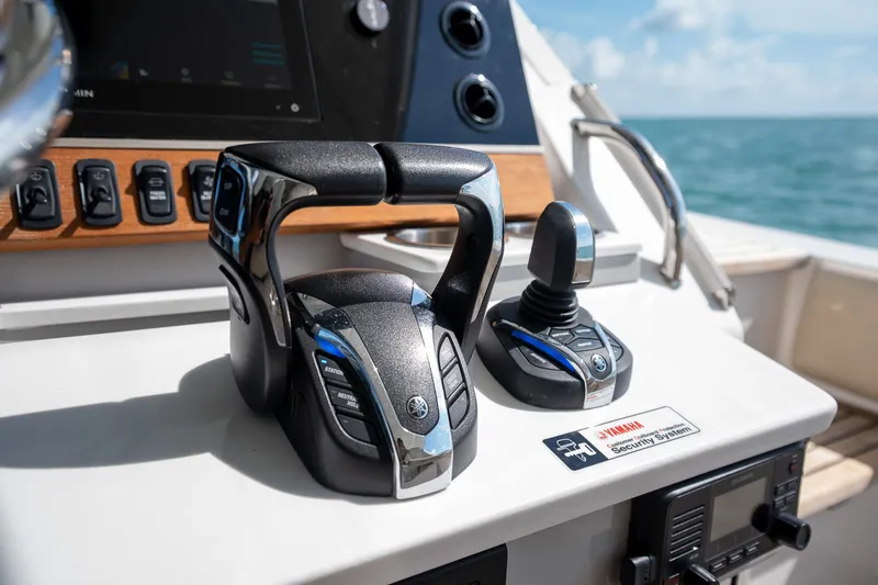 Slide: The Image of Control panel of 2022 Regal 38 SAV boat with Yamaha throttle and joystick. - 38