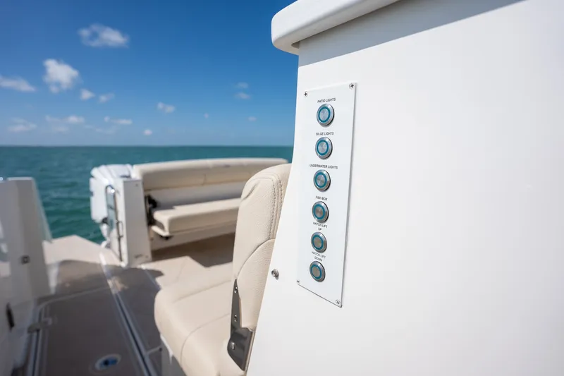 Slide: The Image of 2022 Regal 38 SAV boat interior with control panel and seating, ocean view. - 50