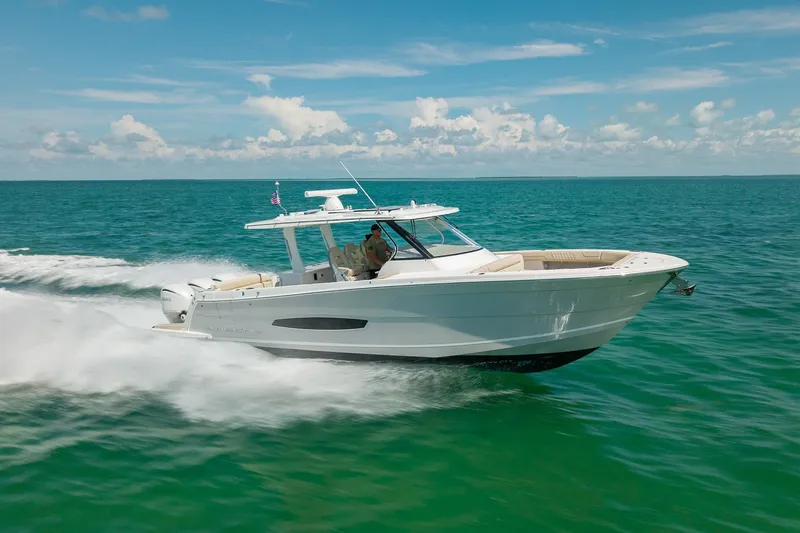 Slide: The Image of 2022 Regal 38 SAV cruising on clear blue ocean waters under a sunny sky. - 13