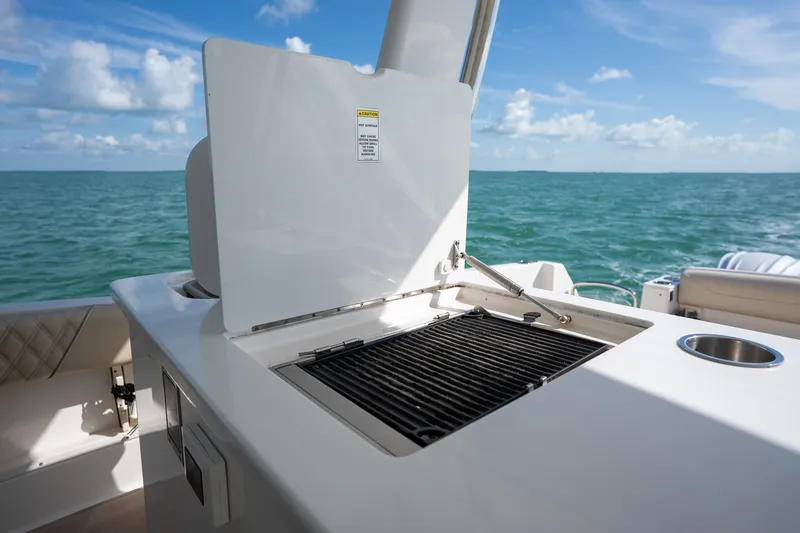 Slide: The Image of Outdoor grill on 2022 Regal 38 SAV yacht with ocean view. - 24