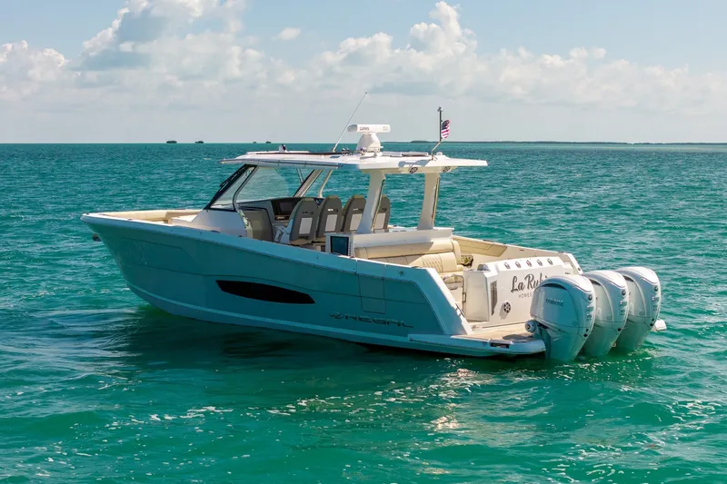 Slide: The Image of 2022 Regal 38 SAV boat cruising on clear blue ocean waters. - 5