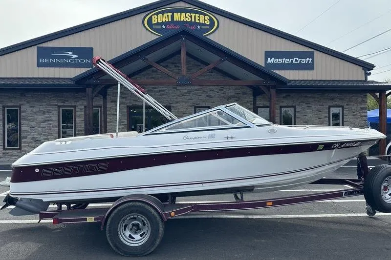 The Image of 2000 Ebbtide Campione 182 boat on trailer outside dealership. - 1
